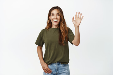 Portrait of middle aged mother, happy friendly woman waving hand, saying hello, greeting you and...