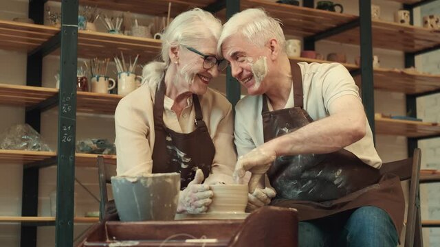Pottery Art, Senior Couple, Mutual Support, Elderly Age. Happy seniors woman and man during pottery