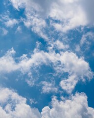 Obraz premium The white clouds in the bright blue sky.