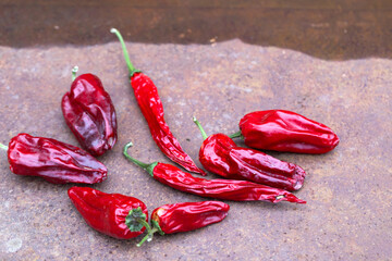 Dried peppers on a rusty table