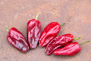 Dried peppers on a rusty table