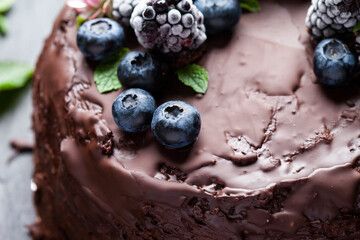 An example of decorating a chocolate cake with fresh berries and flowers