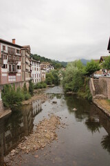 River with stones and with the reflection of the houses in Elizondo