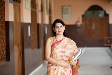 portrait of Smiling teacher in School corridor