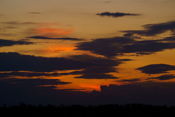 beautiful sunset sky, bright sunlight and silhouette of clouds as a background