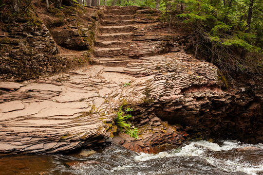 Geological formation of layers and stone stairs in the woods
