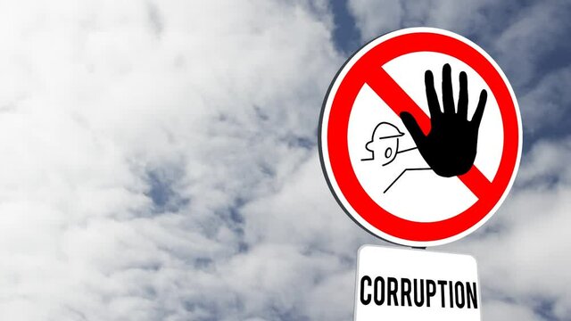 Signboard post with stop corruption text against clouds in the blue sky