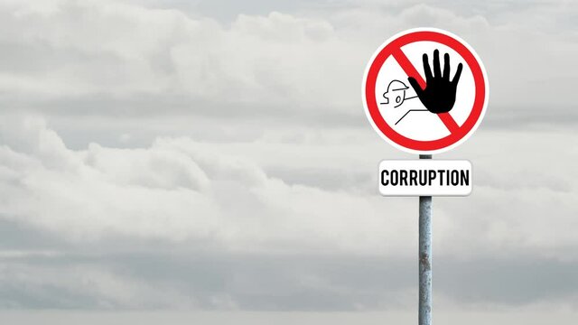 Signboard post with stop corruption text against clouds in the sky