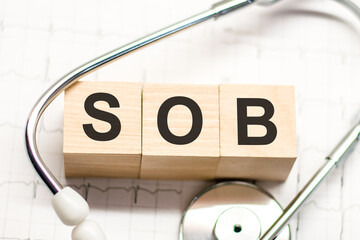 sob word written on wooden blocks and stethoscope on light white background