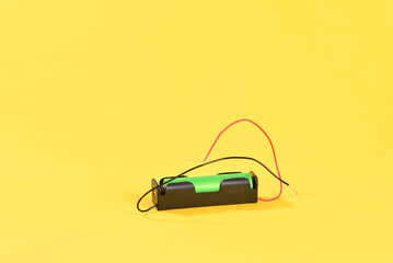 Lithium battery on yellow background.