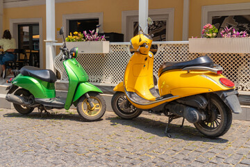 Green and yellow scooters on the street of the city of Tbilisi