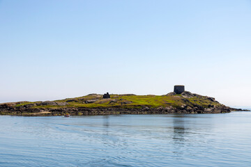 Dalkey Island with church ruin and martello tower on Summer day. Irish Sea. coast, Dublin, Ireland....