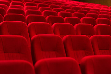 An empty cinema room with red velvet seats. Empty cinema.	