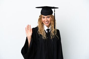 Young university graduate isolated on white background saluting with hand with happy expression
