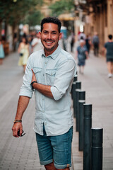 Fototapeta premium Portrait of a dark-haired Latin boy posing for a photo session on a street in the city of Barcelona..