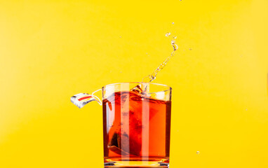 Tea. Black tea in a glass. Spray. Tea bags brewed in a glass.