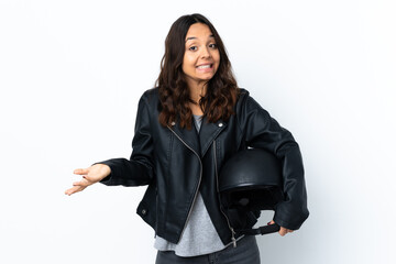 Young woman holding a motorcycle helmet over isolated white background smiling