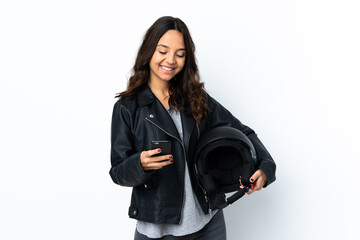 Young woman holding a motorcycle helmet over isolated white background holding coffee to take away...