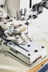 Textile industry, clothing production. Close-up of sewing equipment. Loops and buttons