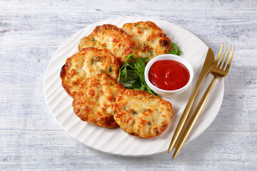 Cheesy Chicken Fritters on a plate, top view