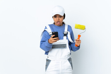 Painter woman over isolated white background surprised and sending a message