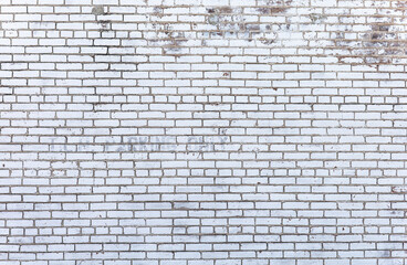Exterior white ancient brick wall, rough surface and unique pattern material for building. Aged with dirt and cracked texture background. Brickwork backdrop at parking lot area.