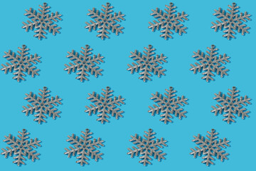 pattern with silver snowflakes on blue background