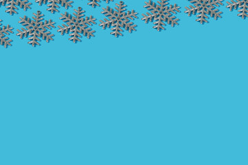 backdrop with silver snowflakes and copy space on blue background