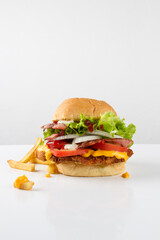 cheese burger, with meat, chicken, bacon, tomatoes, onion, lettuce, potatoes, french fries, ketchup. white background
