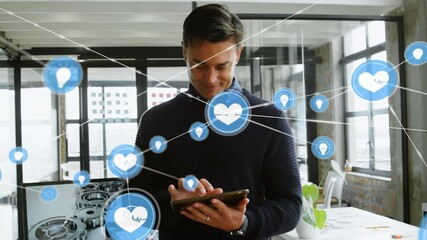 Network of digital icons against caucasian businessman using digital tablet at office