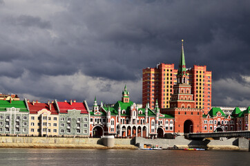Panorama of the Spasskaya Tower, the wedding palace building and the theatre bridge under a gloomy sky. Russia Yoshkar Ola 01.05.2021. High quality photo