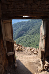 old wooden door in abandoned ruined house in ancient village Gamsutl, Dagestan