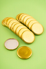 Lids for jars of gold color top view on a green background.