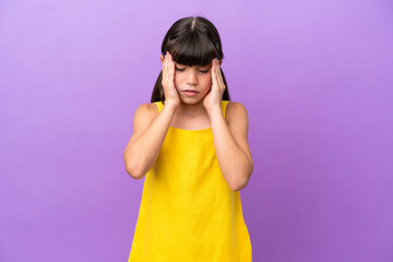 Little caucasian kid isolated on purple background with headache