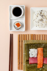 making sushi, ingredients, salmon, tuna, rice, roll, chopsticks. flat lay
