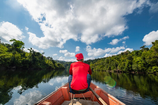 Man exploring the Tatai river on a long tail boat in Cambodia