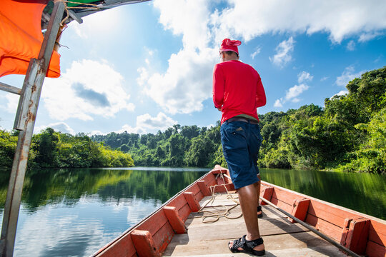 Man exploring the Tatai river on a long tail boat in Cambodia