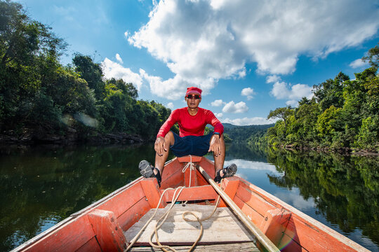 Man exploring the Tatai river on a long tail boat in Cambodia