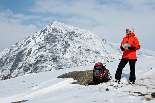 woman reading map at orientating at Mount Tryfan in north Wales