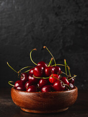 Cherie on dark background / Focused fresh cherie on stone plate