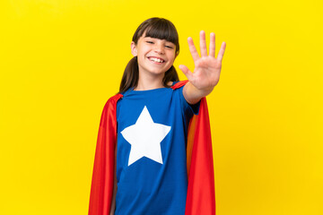 Little super hero kid isolated on purple background counting five with fingers © luismolinero