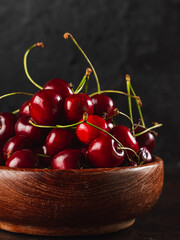 Cherie on dark background / Focused fresh cherie on stone plate