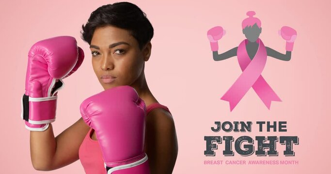 Animation of pink ribbon logo with breast cancer text over woman wearing boxing gloves