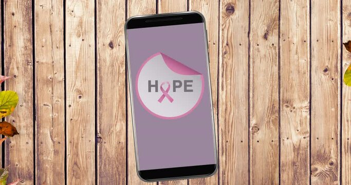 Animation of pink breast cancer ribbon logo with hope text on smartphone screen