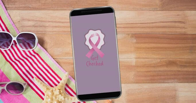 Animation of pink breast cancer ribbon logo with breast cancer text on smartphone screen