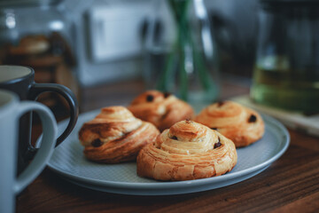 Homemade traditional breakfast: coffee with bun, snail with raisins.