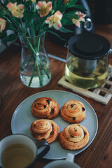 Homemade traditional breakfast: coffee with bun, snail with raisins.