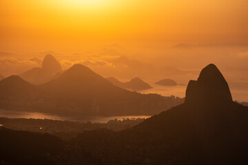 Beautiful orange sunrise view to rainforest mountains in Tijuca Park