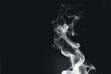 White smoke creating abstract shapes on a black background