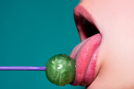 Licking lips. Sensual red lips with candy for print. Red lollipop in the mouth in art design. Glossy womans lips licking sucking lollipop. Sensual sexy mouth with candy concept enjoyment beautiful